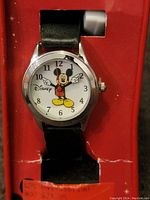 Vintage Disney Mickey Mouse watch in original red packaging showing the watch face with Mickey's arms as hands and black leather strap.
