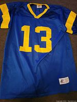 Front view of the blue football jersey with yellow number 13, showing mesh fabric and color accents.