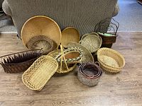Full view of all eleven baskets arranged on floor showing size variation and basket styles.