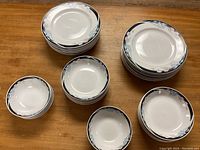 Top view of most of the set items arranged on a wooden table showing the different plates and bowls.