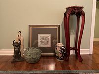 Photo showing all six items in the lot together on the floor including figurines, vases, pedestal, and framed art