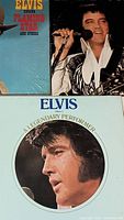 Close-up photo showing three Elvis Presley vinyl album covers with Elvis Sings Flaming Star and Others, and two volumes of Elvis A Legendary Performer featuring close-up portraits of Elvis.