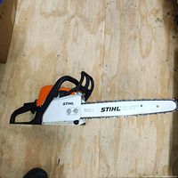 Left side view of Stihl MS 170 chainsaw showing chain bar and handle.