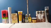 Photo of the entire lot showing all hair care products and shower sponges lined up with tape measure behind for scale.