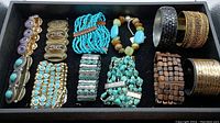 Overview photo showing all 12 bracelets displayed in a tray including turquoise, metal, wooden, and beaded styles.