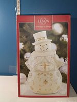 Box showing the Lenox brand Snowman cookie jar with the red and white packaging and product image on front.