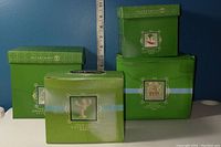 Four green boxes of Snowbabies Sentiments Classic Collection showing front labels and brand