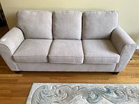 Full front view of sofa on hardwood floor