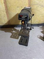 Front view of the drill press showing the branding label and speed specifications.