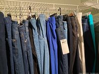 Lot of ladies pants of various brands including denim and colored pants all XL size 16 on hanger