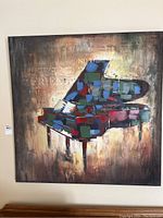 Front view of the square canvas print showing the colorful abstract grand piano with text in background.
