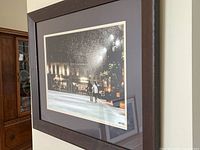 View of the entire framed art print showing the skating rink scene in Kingston at night.