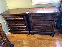 Front view of both nightstands side by side on hardwood floor.