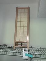 Full view of the lamp from the front showing wooden frame, paper panels, and lamp height.