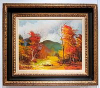Front view of the framed oil painting showing the bright autumn landscape and ornate vintage wood frame