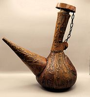 Side angle showing the full leather-wrapped vintage wine decanter with attached stopper and decorative embossing.