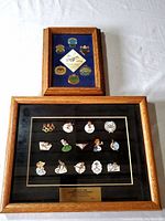 Two framed pin collections, one for the 1988 Calgary Winter Olympics with 14 pins, and one Dodgers set with 7 pins.