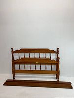 Full view of bed frame components laid out showing headboard, footboard, and side rails.