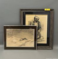 Image showing both framed drawings together: a portrait of a man and a winter landscape.