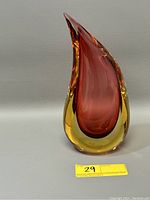 Front angled view of mid-century modern amber and cranberry red art glass vase with pointed asymmetrical peak and smooth finish.