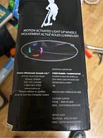 Close-up of the box side showing motion activated light-up wheels feature and manufacturer info.