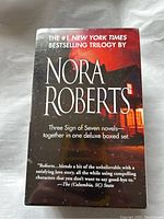 Front view of the Nora Roberts Sign of Seven Trilogy deluxe boxed set with visible cover text and quote, unopened in original packaging.