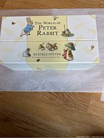 Top view of the closed box showing the title 'The World of Peter Rabbit' and Beatrix Potter illustrations on the cover.