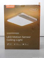 Packaged box depicting product: LED Motion Sensor Ceiling Light 2 Pack, showcasing warm and cold white light options, motion sensor, 3 color temperatures, and high brightness features.