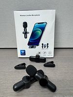 Box packaging showing wireless lavalier microphone for iPhone with image of microphone and phone on front, some feature icons.