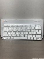 Front view of MEETION iKey K210 wireless keyboard showing white low-profile keys and Apple-style layout.