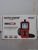 Box of the MOTOPOWER MP69038 Car Diagnostic Tool showing branding, device image, and main uses.
