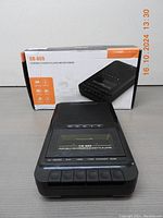 Front view of CR-669 Portable Cassette Player and Recorder with control buttons and visible cassette compartment, box in background.