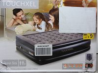 Front of box showing full image of black TOUCHXEL queen size air mattress with tufted top and family image, showing product in use.