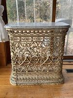 Front view of console table showing ornate cast iron base and marble top