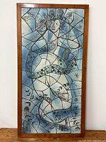Full front view of the rectangular mosaic tile panel in its wood frame
