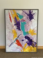 Front view of the framed abstract oil painting with visible signature and color details.
