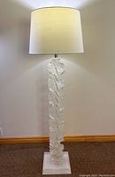 Full frontal view of floor lamp showing shade and acrylic spiral column