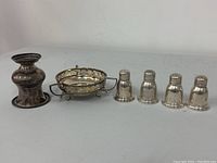 All items displayed: candle holder, dish, and four shakers