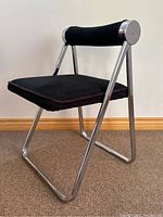 Angled view showing front and left sides of chair, spotlighting frame and upholstery