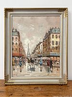 Framed oil painting of a Paris street scene featuring the Eiffel Tower in the distance, with people walking and a horse-drawn carriage, viewed from the front.