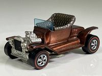 Front side view of 1967 Mattel Hot Wheels Hot Heap in Root Beer metallic with redline tires and exposed engine detail.