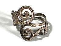 Front and side view of sterling silver filigree ring showing swirling openwork design with beaded details.