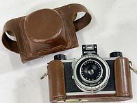 Kodak 35 camera with leather case beside it, showing overall camera and case condition