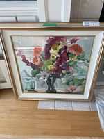 Full view of the framed watercolor painting showing floral scene.