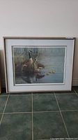 Framed lithograph showing nature scene with geese and goslings, with signature and numbering visible.