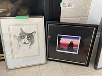 Framed original watercolor painting of cat named Toby by Anne MacKenzie with grey fur, green eyes, named 'Toby', next to framed print 'Siwash Rock' by Roy H. Vickers