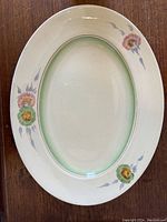 Top view of oval platter showing floral decoration and green rim detail