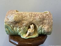 Side view of the Sylvac pottery planter showing the gnome figure in the hollow of the tree log shape.