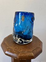 Front angle view of blue knobbly Whitefriars glass vase showing original label and textured surface.