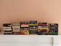 Wide shot of all fiction books stacked in rows showing a variety of titles and authors in paperback format.